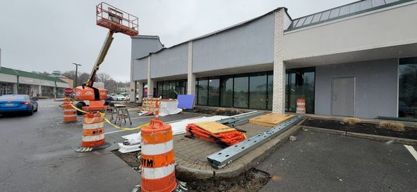 Construction equipment and materials in front of a building