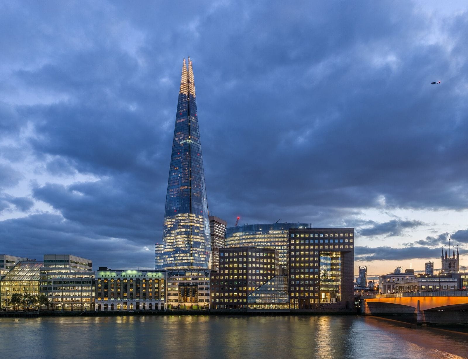 The Shard and London Bridge Hospital at sunset, seen across the Thames.