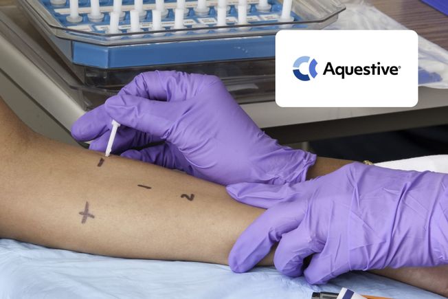 Gloved hands performing an allergy skin prick test