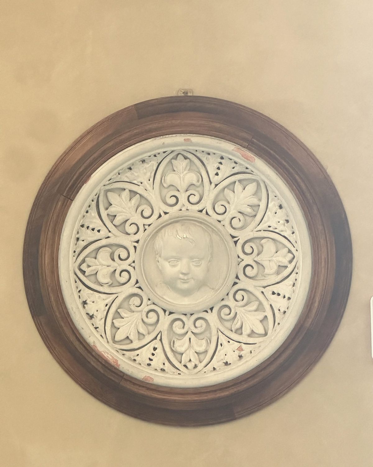 A child's face, boxed in stone
