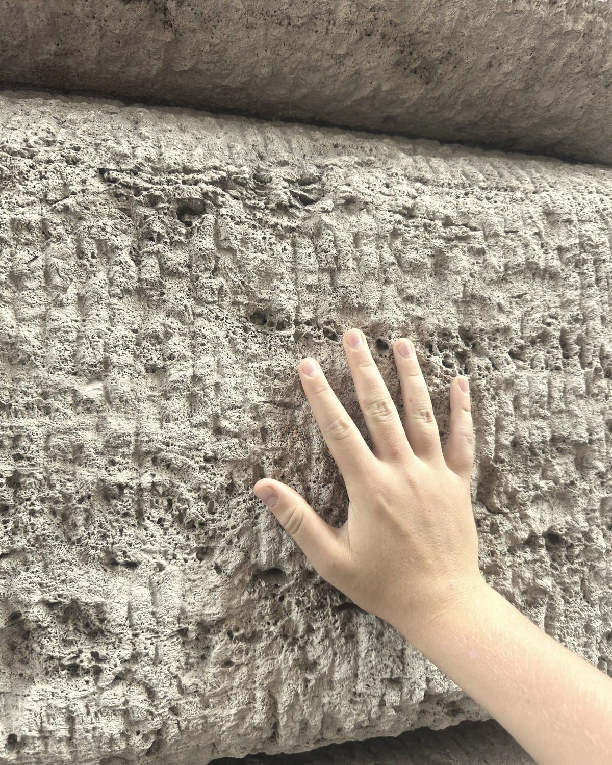 Hand on travertine (Vatican wall)