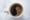 A top down image of a white cup with black coffee that looks to be burnt 