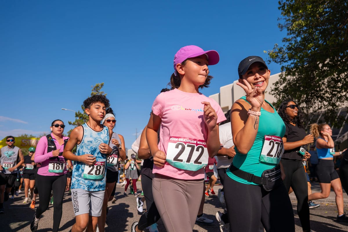 Participants at a previous NMSU Gratitude Walk/Run make their way across campus on a sunny morning.