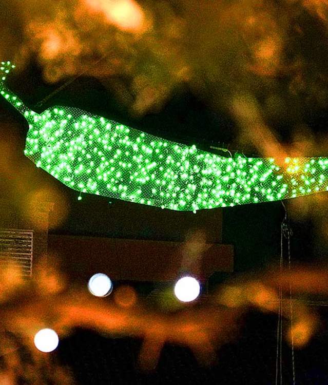 Close-up of the illuminated green chile pepper suspended above downtown Las Cruces during the city’s annual New Year’s Eve Chile Drop celebration.