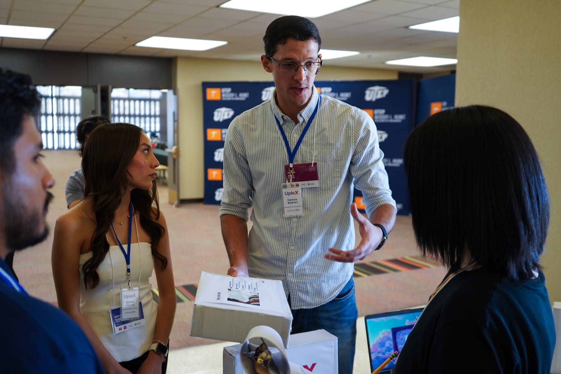 New Mexico State University student Hamzah Badrari discusses his team’s project with judges during the Negotium 2025 binational business competition at the University of Texas at El Paso.