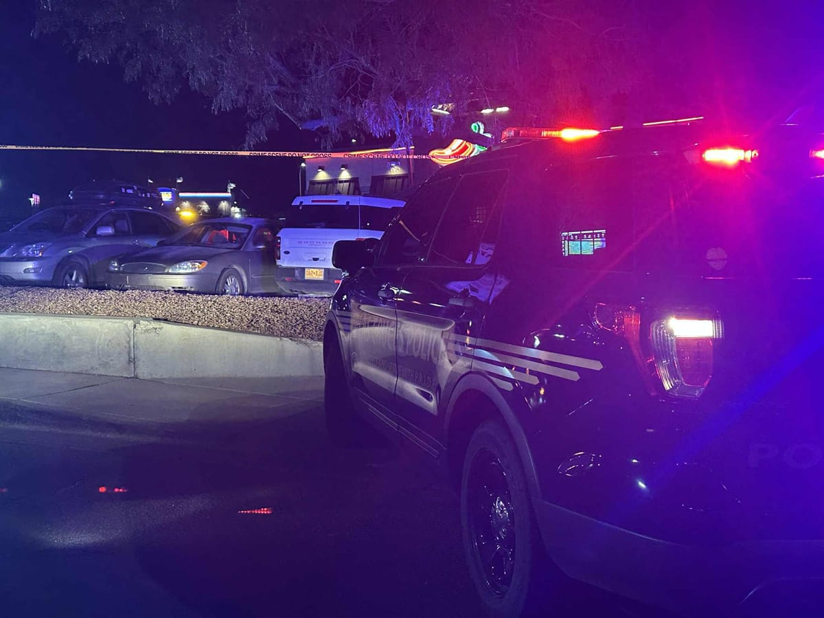 Las Cruces police vehicles with flashing lights block the parking lot of Chili’s on Telshor Boulevard as investigators process the scene of a fatal shooting on Thursday night.