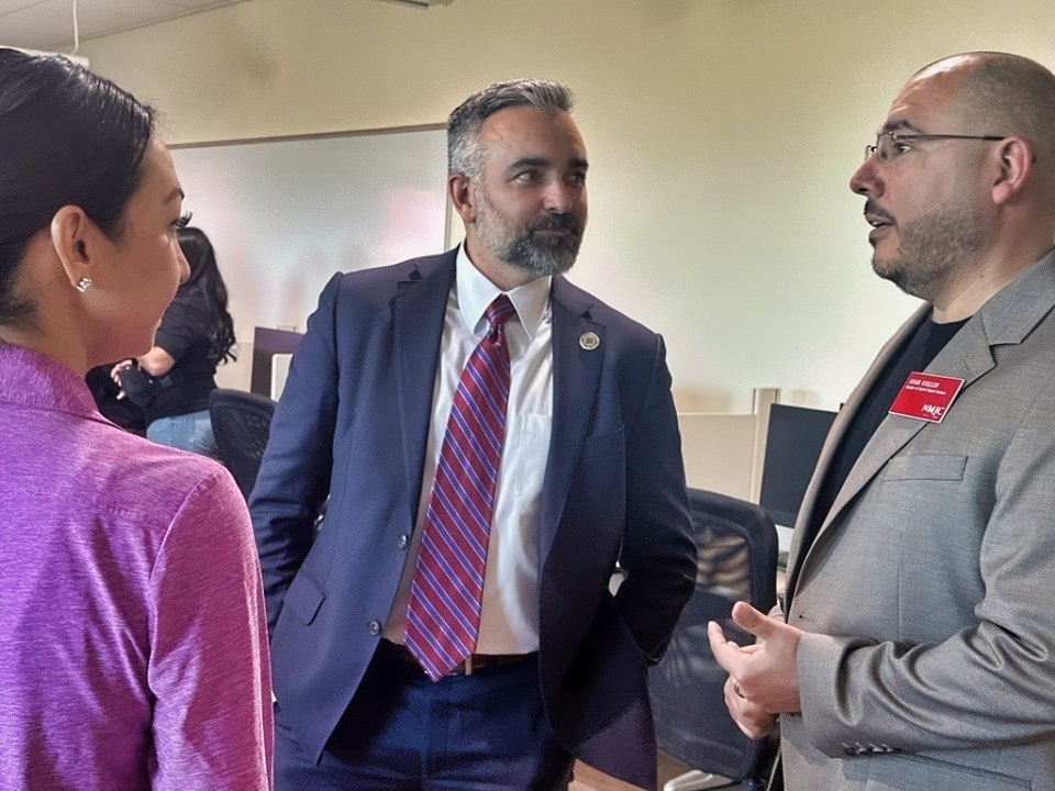 Attorney General Raúl Torrez talks with New Mexico Junior College staff members inside a campus classroom during a visit in Hobbs.