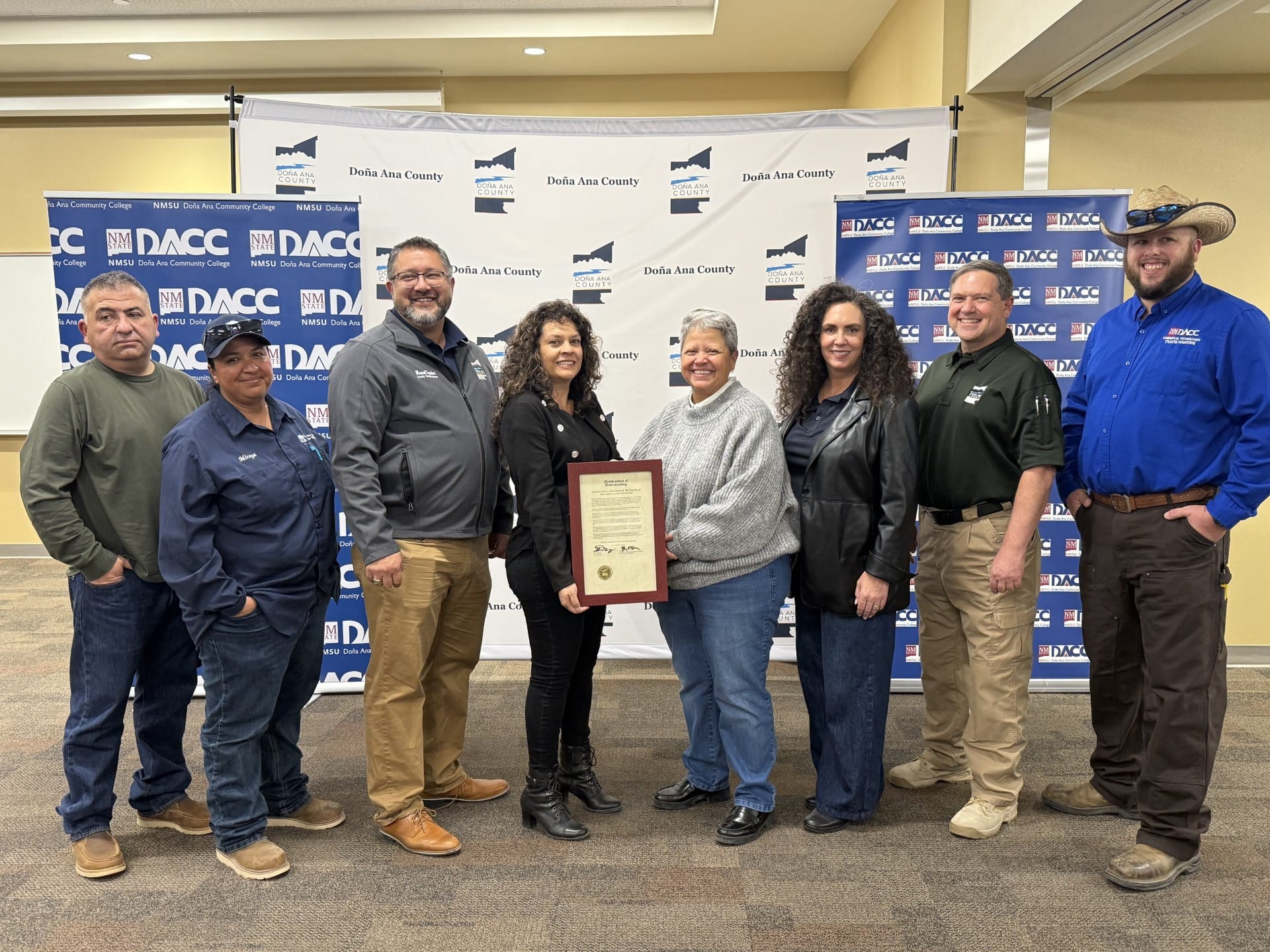 Doña Ana County and Doña Ana Community College officials stand together indoors holding a signed memorandum, marking a new water technology internship partnership.