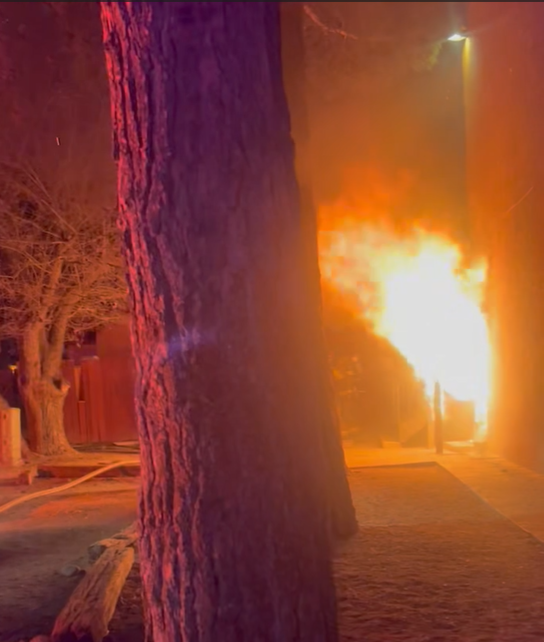 Flames visible from an apartment unit at night as firefighters respond to a structure fire on West Madrid Avenue in Las Cruces.