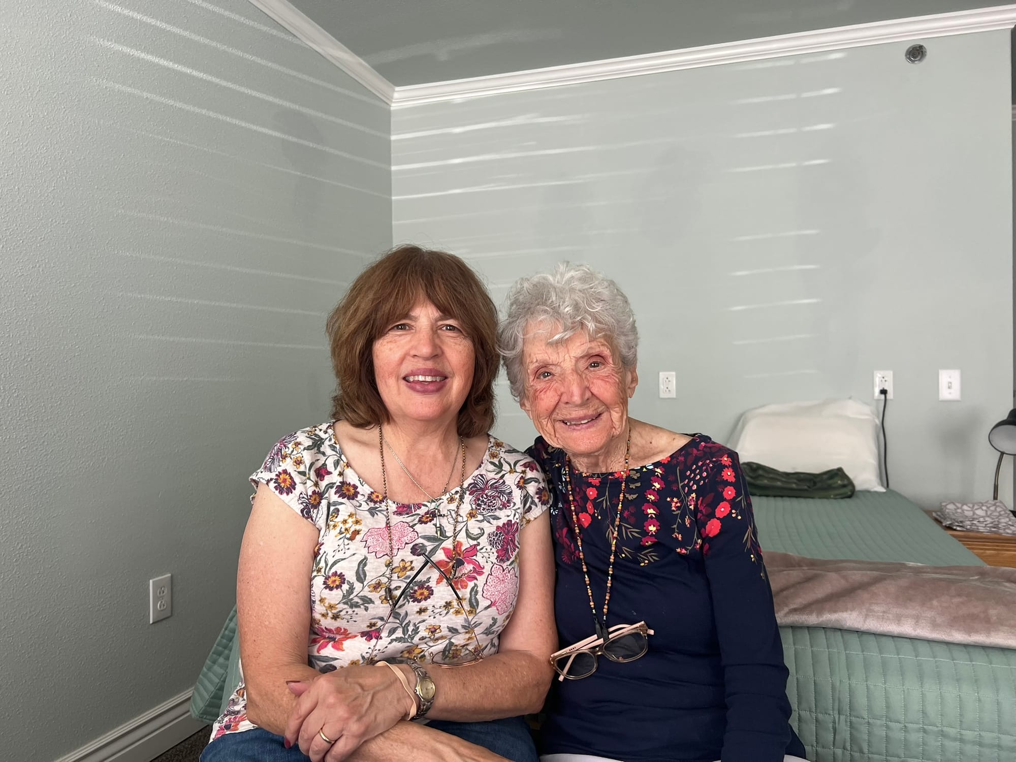 Karen LeCompte of La Luz sits beside her mother, Arlene Maclean of Alamogordo, inside a bedroom; both contracted measles as children before vaccines were available.