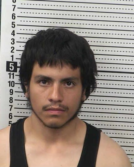 Booking photo of Francisco Longoria Mata taken against a height chart backdrop.