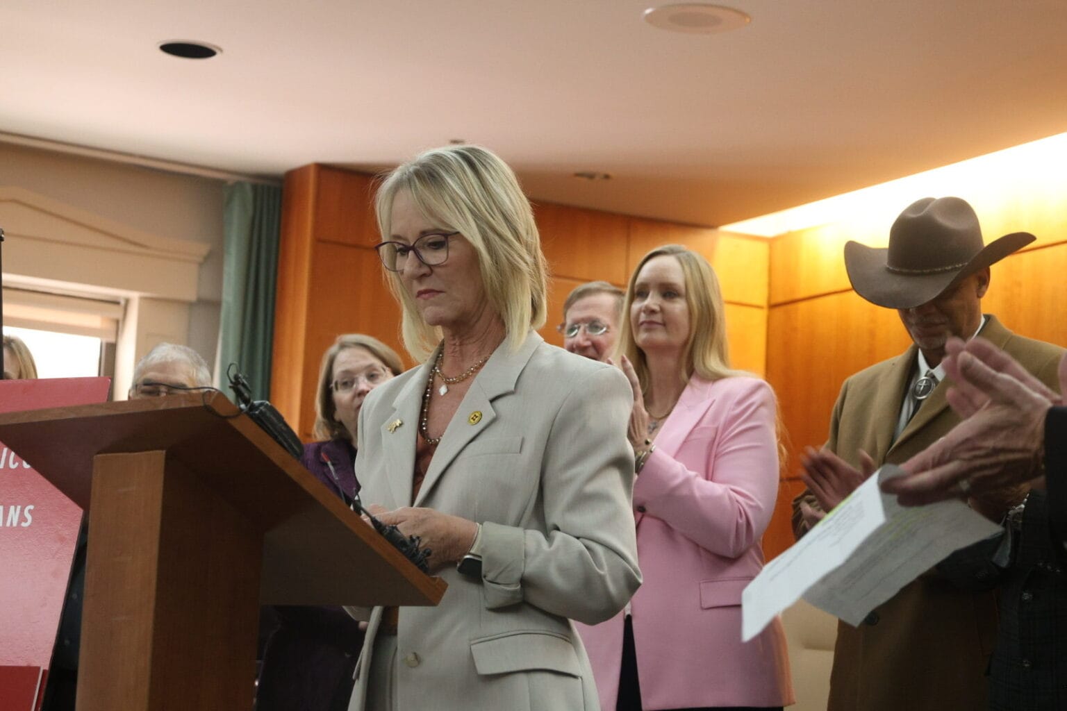 House Minority Leader Rep. Gail Armstrong speaks at a podium during a Feb. 19 news conference at the Roundhouse, with Republican lawmakers standing behind her.