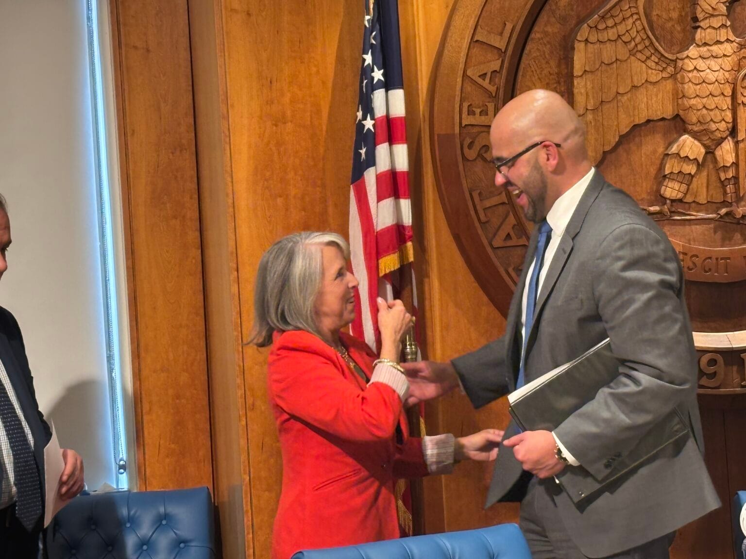 Gov. Michelle Lujan Grisham and House Speaker Javier Martínez speak together following a Feb. 19 news conference at the Roundhouse about the 2026 legislative session.