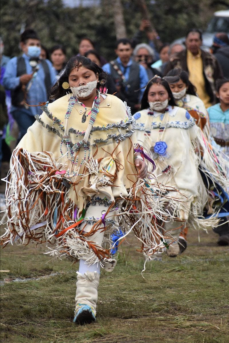Participants in traditional dress take part in a Mescalero Apache coming-of-age ceremony in 2021.