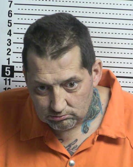 Booking photo of James Manuel Arellano wearing an orange detention uniform in front of a height chart at the Doña Ana County Detention Center.