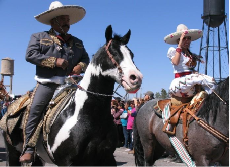 Charro riders in traditional Mexican attire on horseback participate in the Cabalgata Fiesta de Amistad parade in Columbus, New Mexico.
