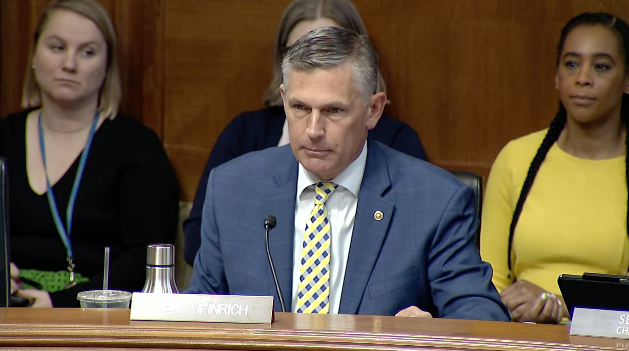 U.S. Sen. Martin Heinrich sits at a committee desk and speaks into a microphone during a Senate hearing.