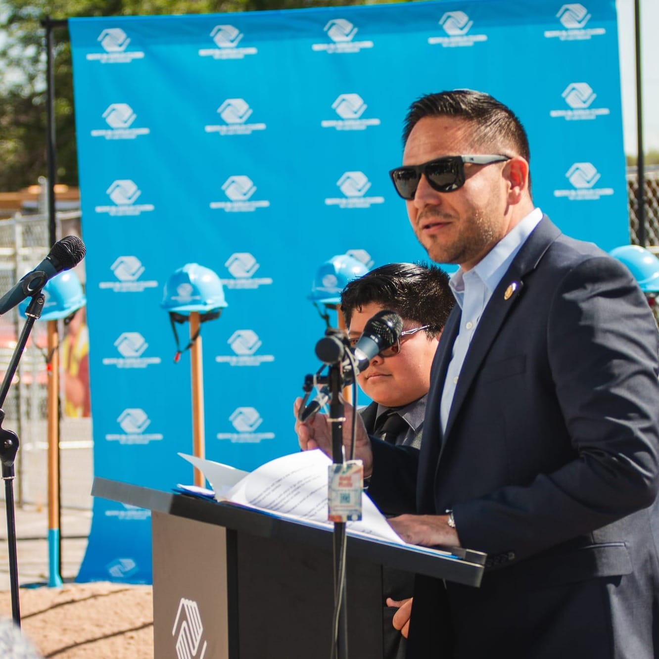 U.S. Rep. Gabe Vasquez speaks at a podium during the Boys & Girls Club of Las Cruces groundbreaking event.