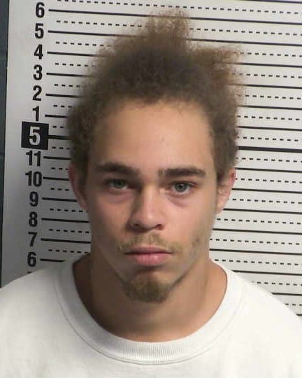 Booking photo of Josiah Carter in front of a height chart at the Doña Ana County Detention Center