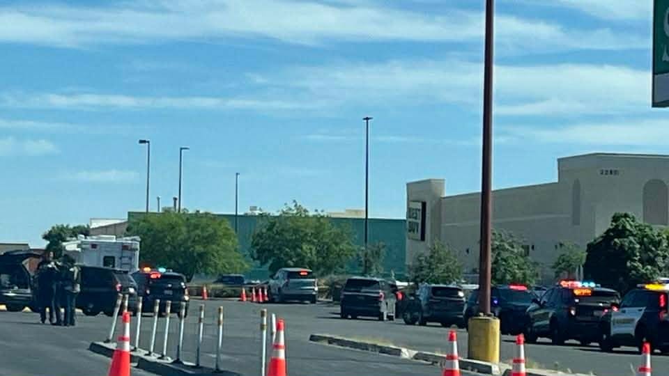 Police vehicles and officers gathered at a scene along Lohman Avenue in Las Cruces following an officer-involved shooting.