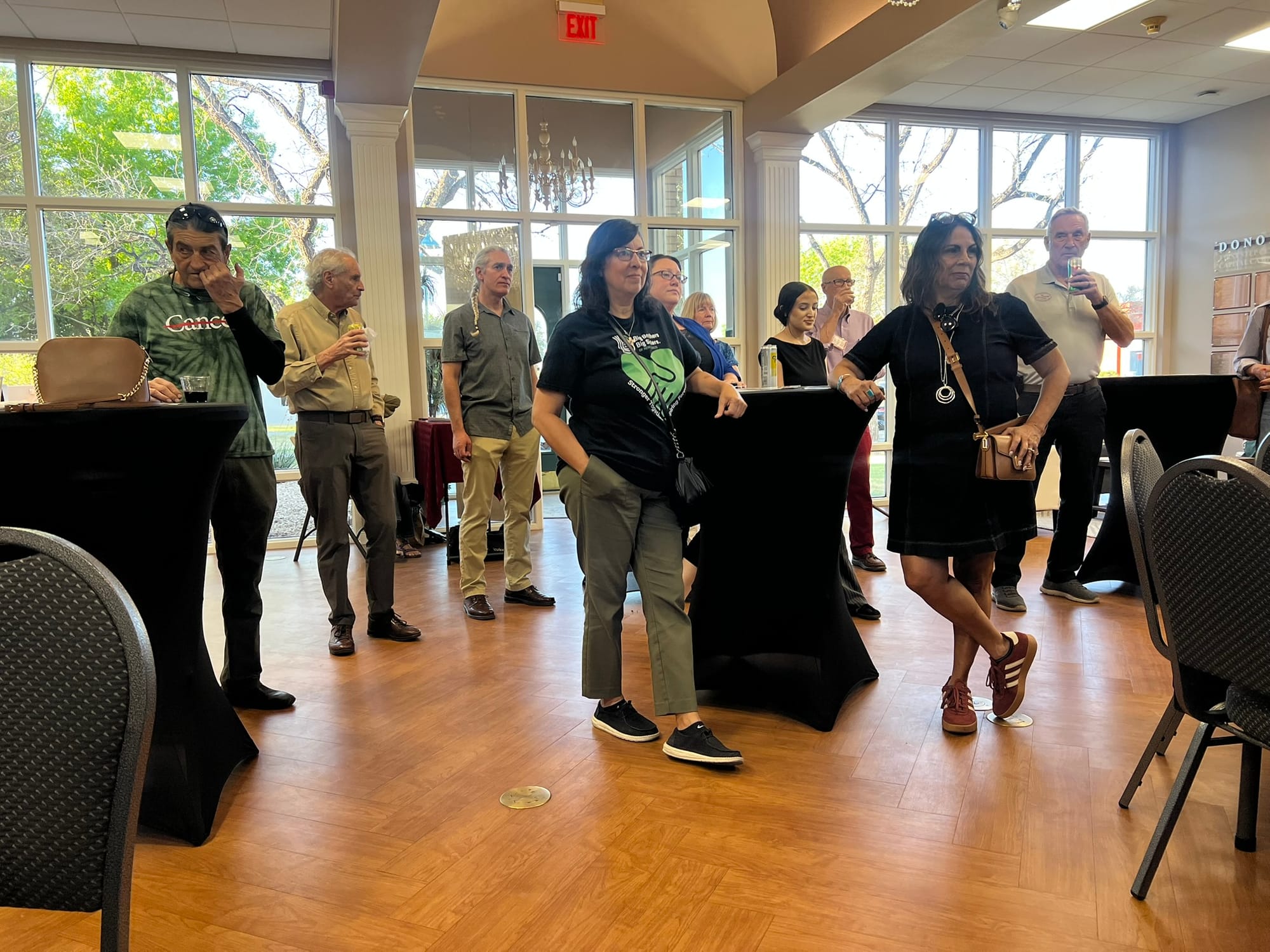 Attendees gather and listen during a Southern New Mexico Giving Day presentation at a Las Cruces Green Chamber of Commerce event.