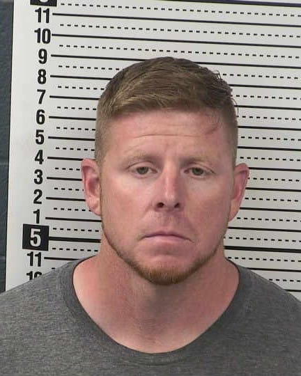 Booking photo of Wyatt Cornelius facing forward with a neutral expression in front of a height chart.