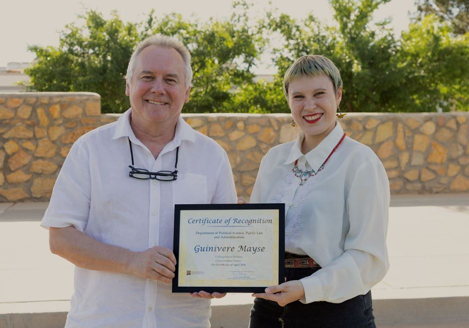 Guinivere Mayse receives a certificate from Neil Harvey during the J. Paul Taylor Social Justice Symposium closing reception at New Mexico State University.