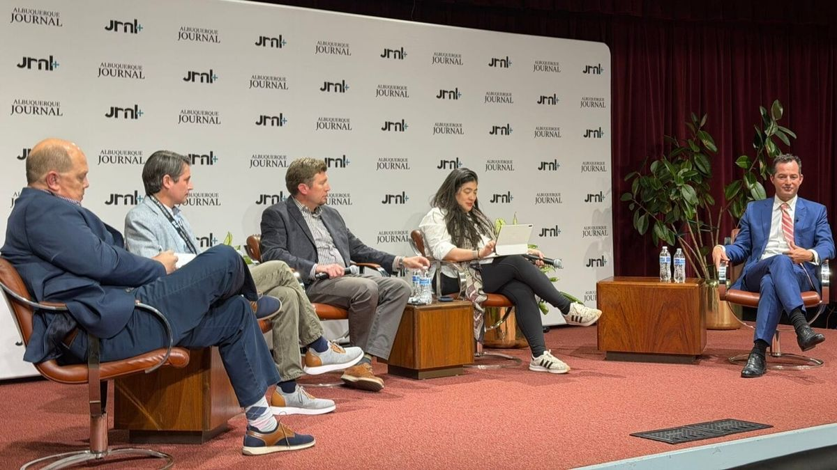 Doug Turner speaks during a panel discussion with journalists at an Albuquerque Journal event, seated on stage with the newspaper's editorial board.