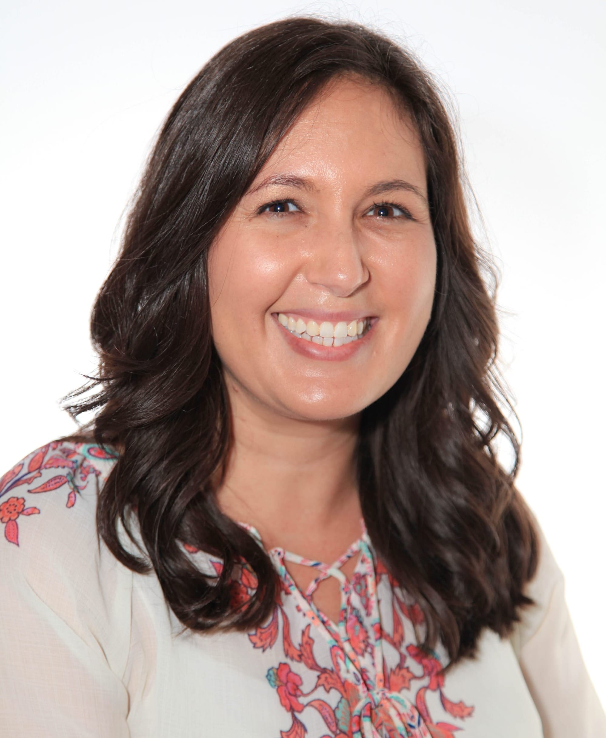 Portrait of Hillary Avitia smiling against an off-white background.