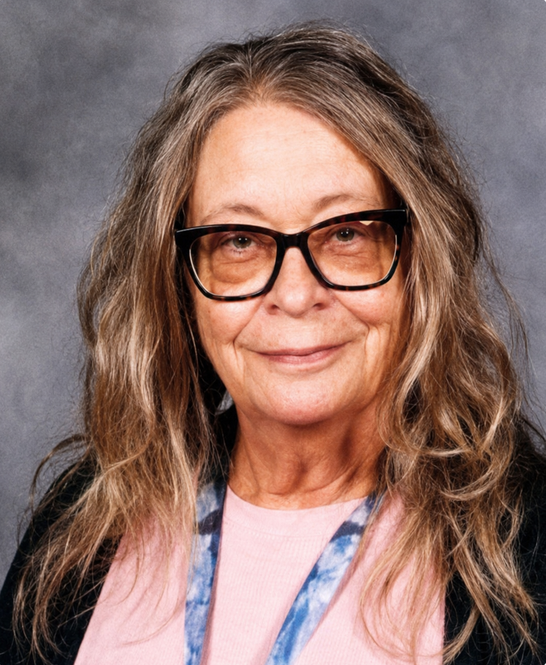 Centennial High School educator Gail Wheeler poses for a portrait photo wearing glasses and a pink top.