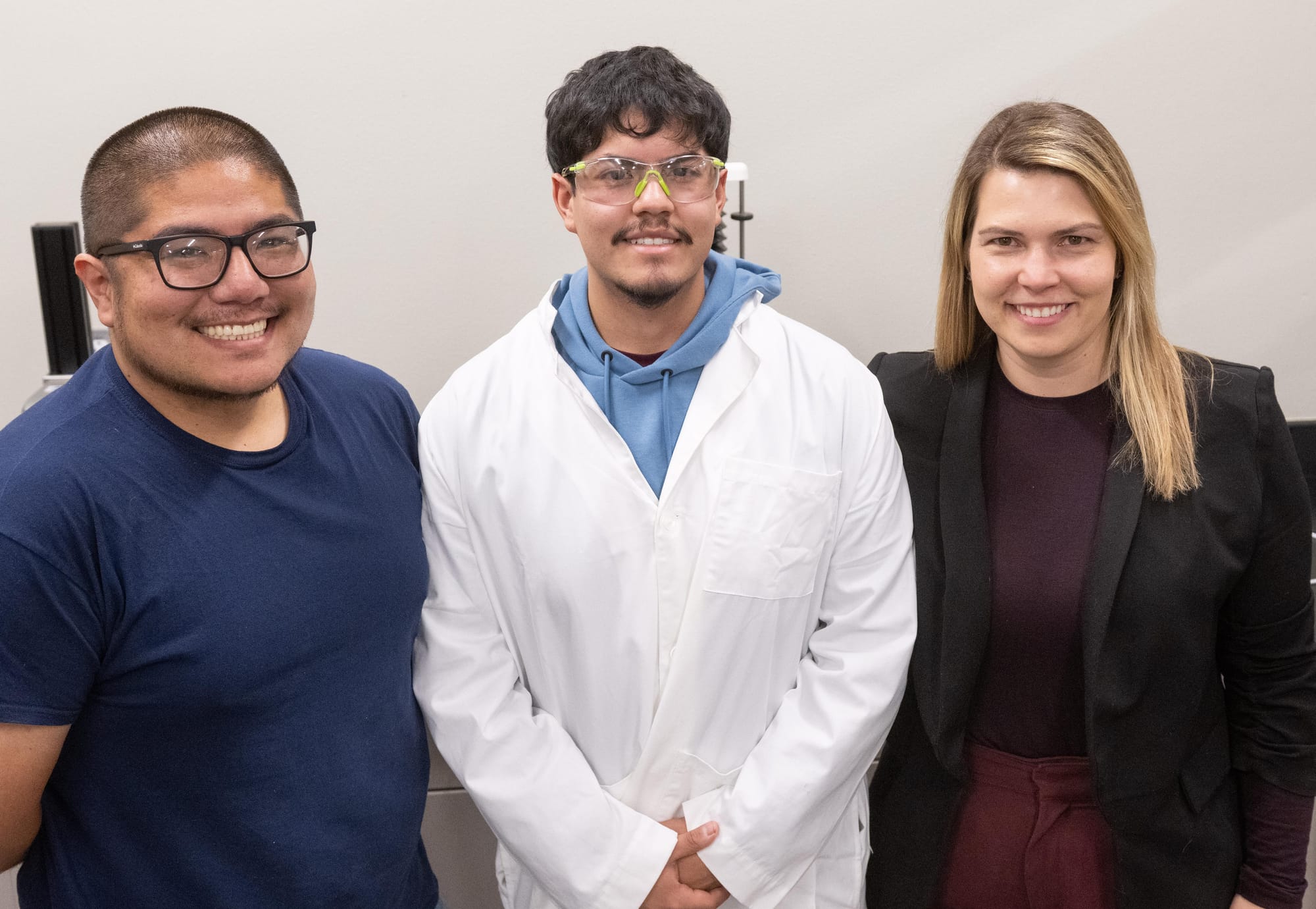 Researchers Gonzalo Miyagusuku-Cruzado, Ismael Trevizo and Francine Mezzomo Giotto stand together in a laboratory at New Mexico State University.