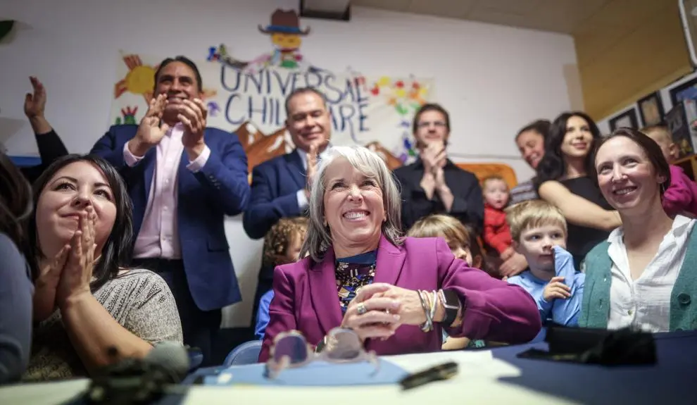 Gov. Michelle Lujan Grisham smiles and celebrates with supporters and children at a gathering marking the signing of universal childcare into law in New Mexico.