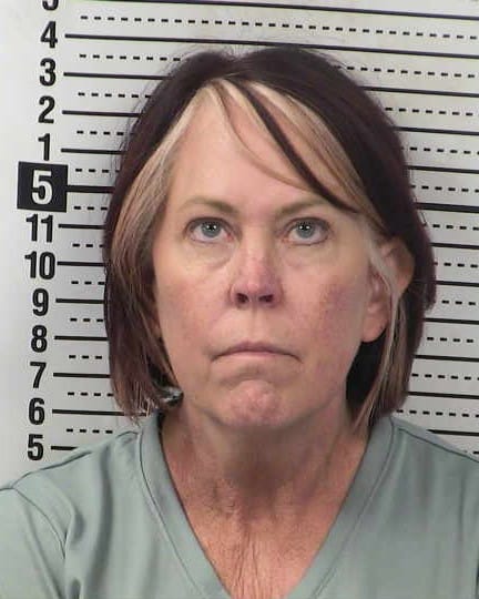 Booking photo of Kimberly Skaggs in front of a height chart.