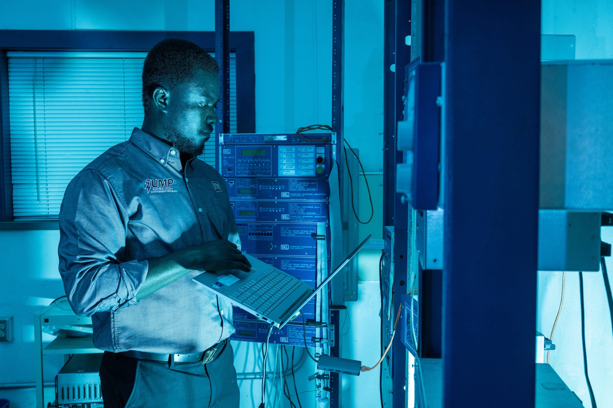 Man standing next to electrical equipment.