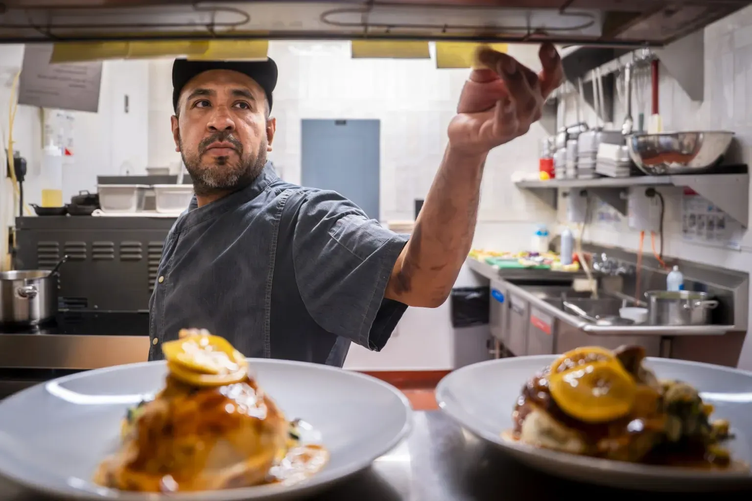 Chef Junior Martinez prepares dishes in a Santa Fe restaurant kitchen.