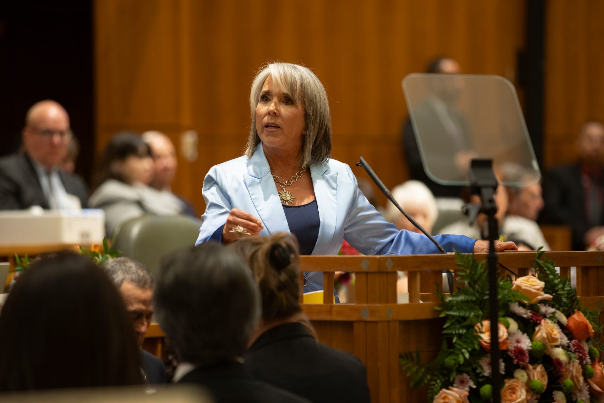 New Mexico Gov. Michelle Lujan Grisham speaks at a lectern in the state House chamber.