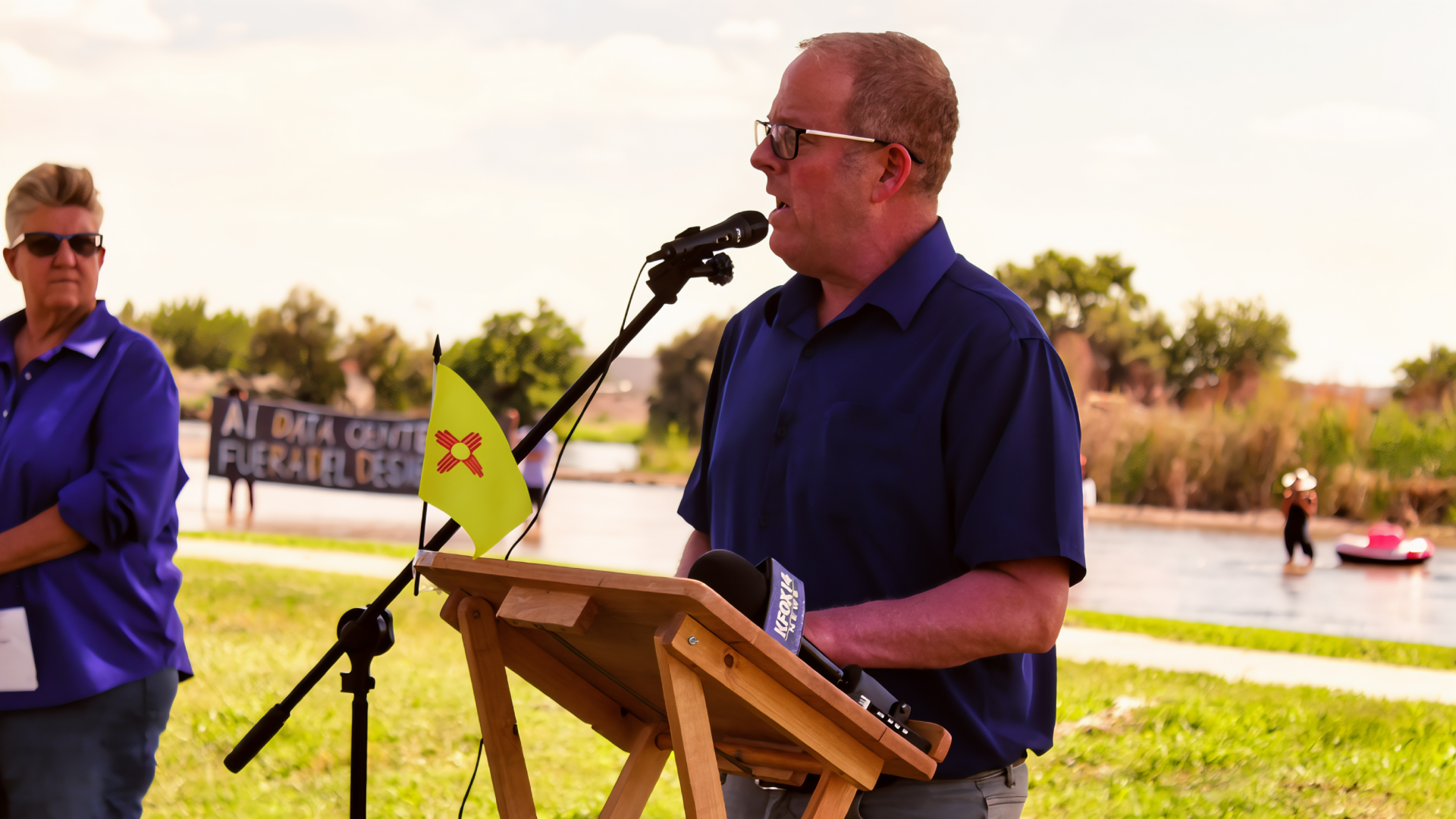 Sen. Jeff Steinborn speaks at a microphone near the Rio Grande during a Project Jupiter press conference.