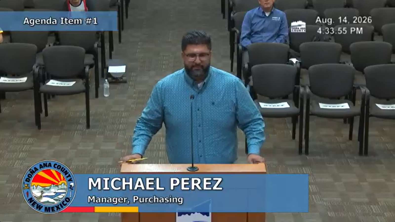 Doña Ana County Purchasing Manager Michael Perez speaks at a podium during the Aug. 14 County Commission special meeting.