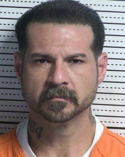 Booking photo of Connard Michael Bowling, 38, wearing an orange jail uniform.