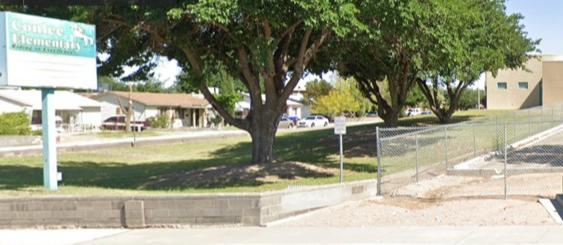 Exterior view of Conlee Elementary School in Las Cruces, with the school sign, trees, lawn and campus buildings visible.