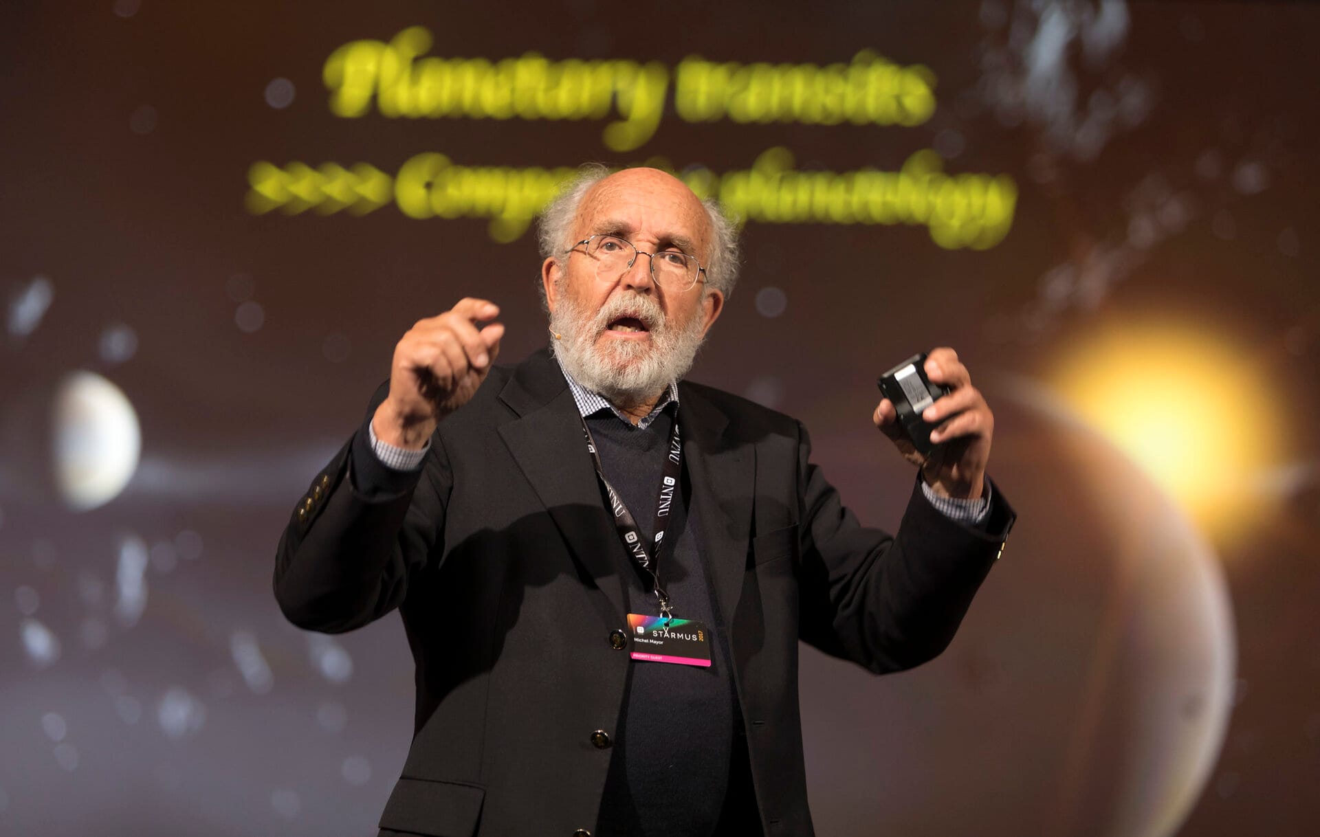Michel Mayor gestures while speaking onstage at the Starmus IV science festival in Trondheim, Norway, in June 2017.