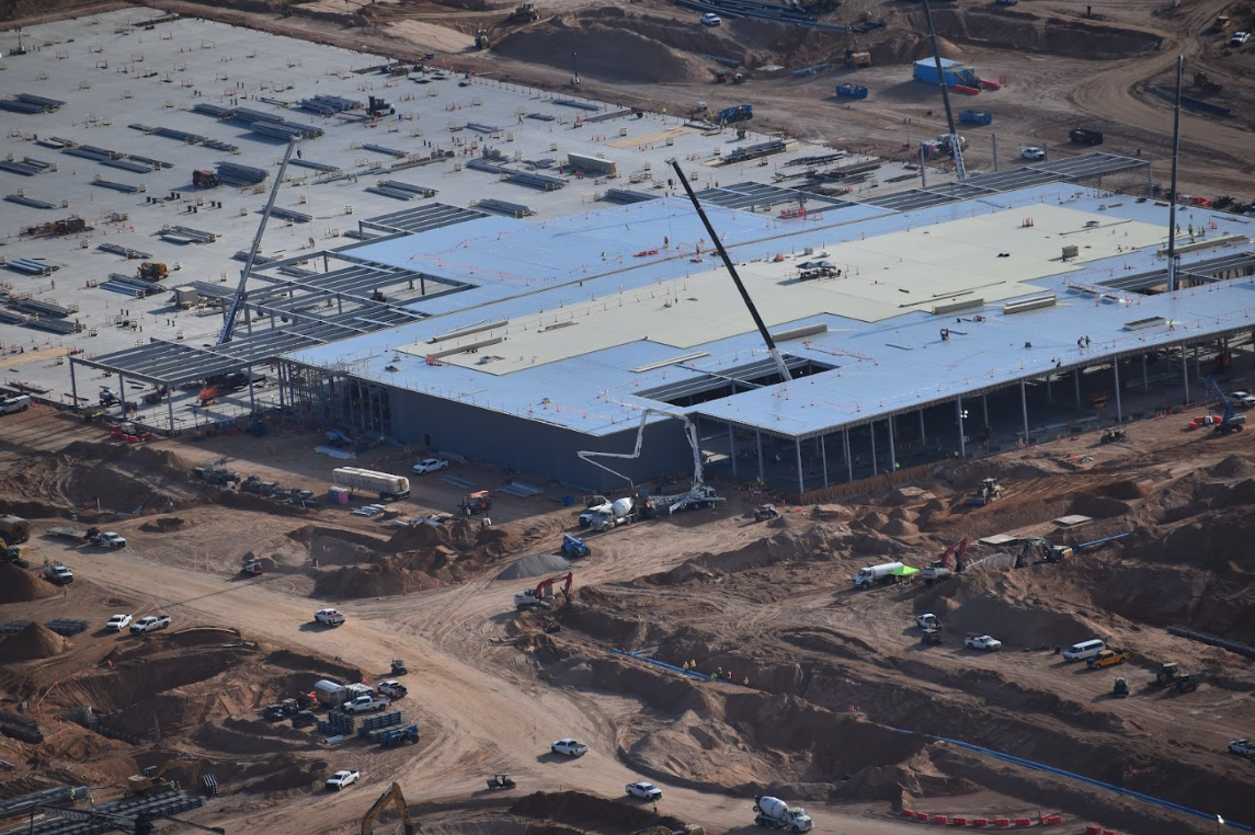 Aerial view of Project Jupiter construction in Santa Teresa, showing a large building under construction, cranes, equipment and earthwork across the site.