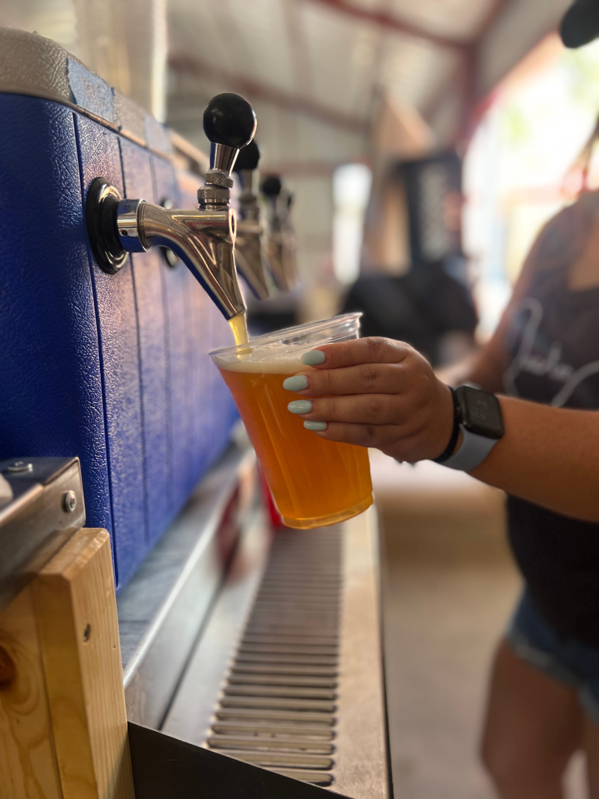Beer is poured from a tap into a plastic cup during a New Mexico State Fair happy hour.