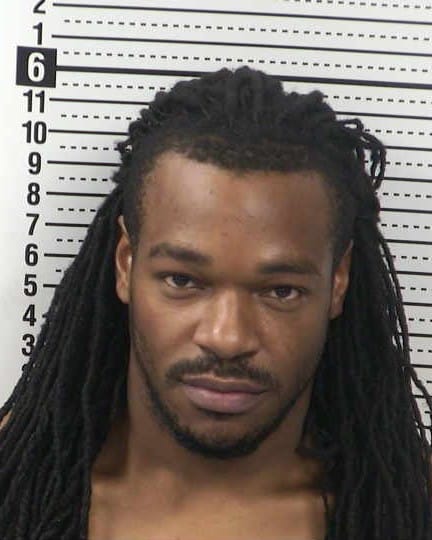 Booking photo of Treyvon Malik Stigler, 30, with long dreadlocks and a dark shirt.