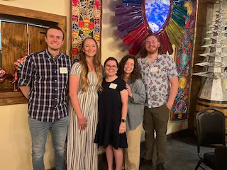 Five newly hired veterinarians in Las Cruces standing together at a welcome event.