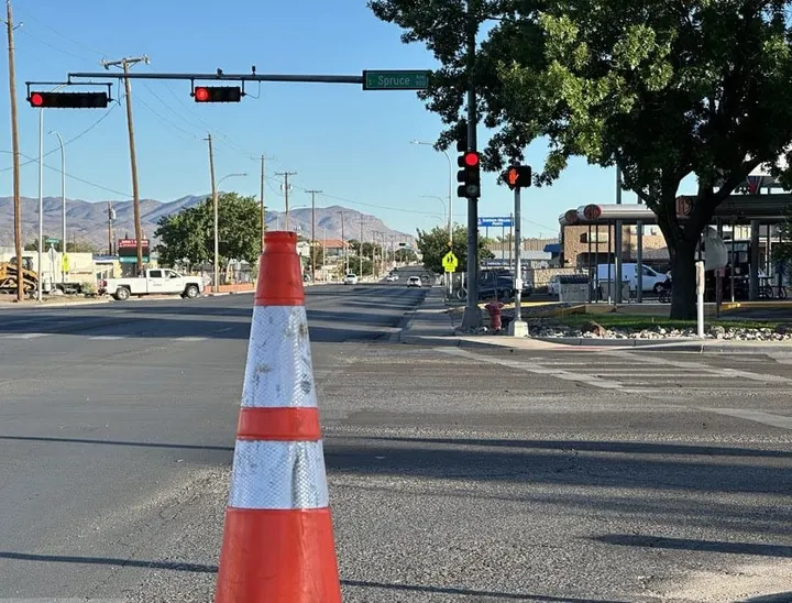 A traffic cone stands in the foreground at the intersection of Solano Drive and Spruce Avenue in Las Cruces, where police say a June 2 road rage shooting occurred.