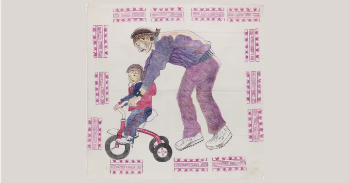 Drawing on a white handkerchief showing a man helping a child ride a tricycle, surrounded by pink geometric border designs.
