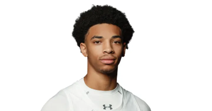 Deshawndre Washington is pictured wearing his white basketball jersey against a white background