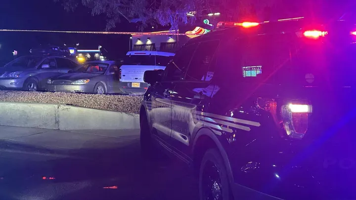 Las Cruces police vehicles with flashing lights block the parking lot of Chili’s on Telshor Boulevard as investigators process the scene of a fatal shooting on Thursday night.