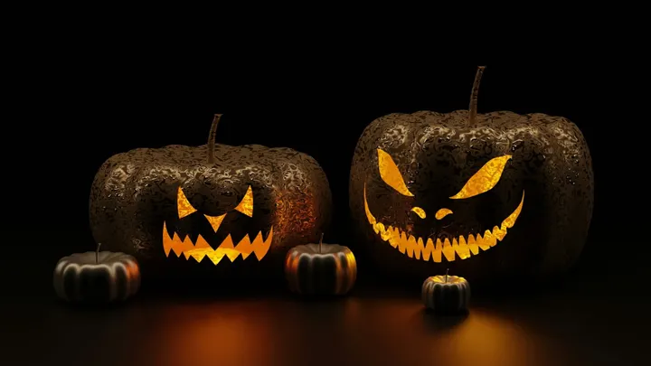 Two glowing jack-o’-lanterns with menacing carved faces sit side by side, flanked by two smaller pumpkins, against a dark background.